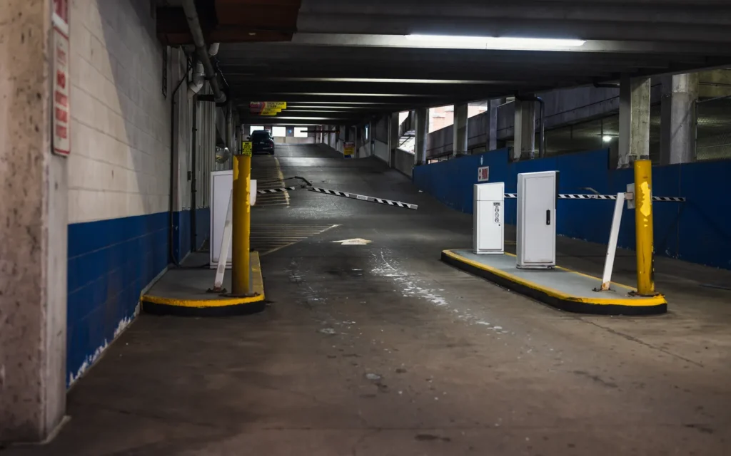 Entrance ramp and barrier gate of an underground parking garage, the kind of residential garage a co-op or condo board is responsible for repairing